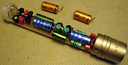The inside of a Schoeps CMC4 microphone with new capacitors and the old ones beside it